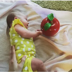 Baby with Down syndrome playing with Happy Apple Toy