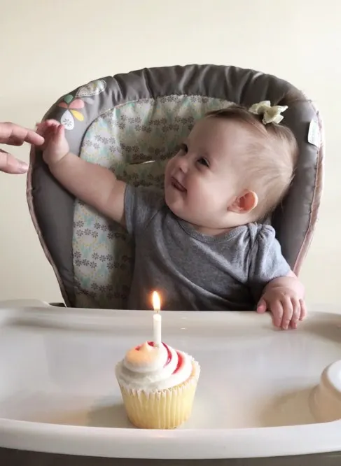 Birthday girl and her birthday cupcake