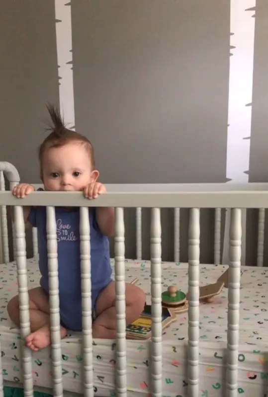 Kara teething on her crib