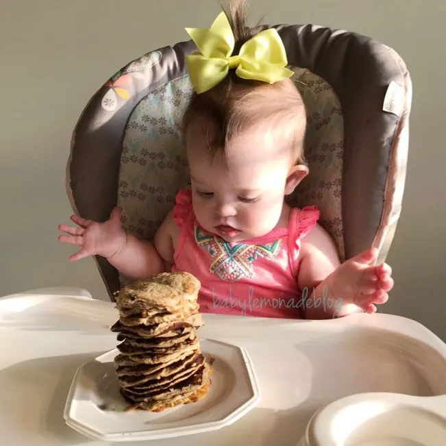 Hungry eyes Kara ready and excited to chow down on her stack of healthy baby pancakes
