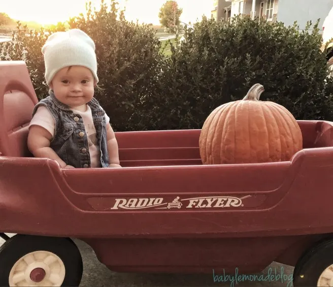Kara in wagon with pumpkin